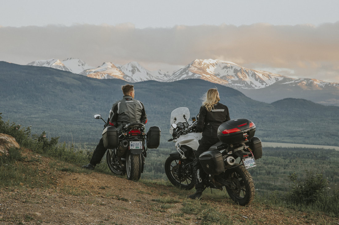 motorcyclists overlooking mountains